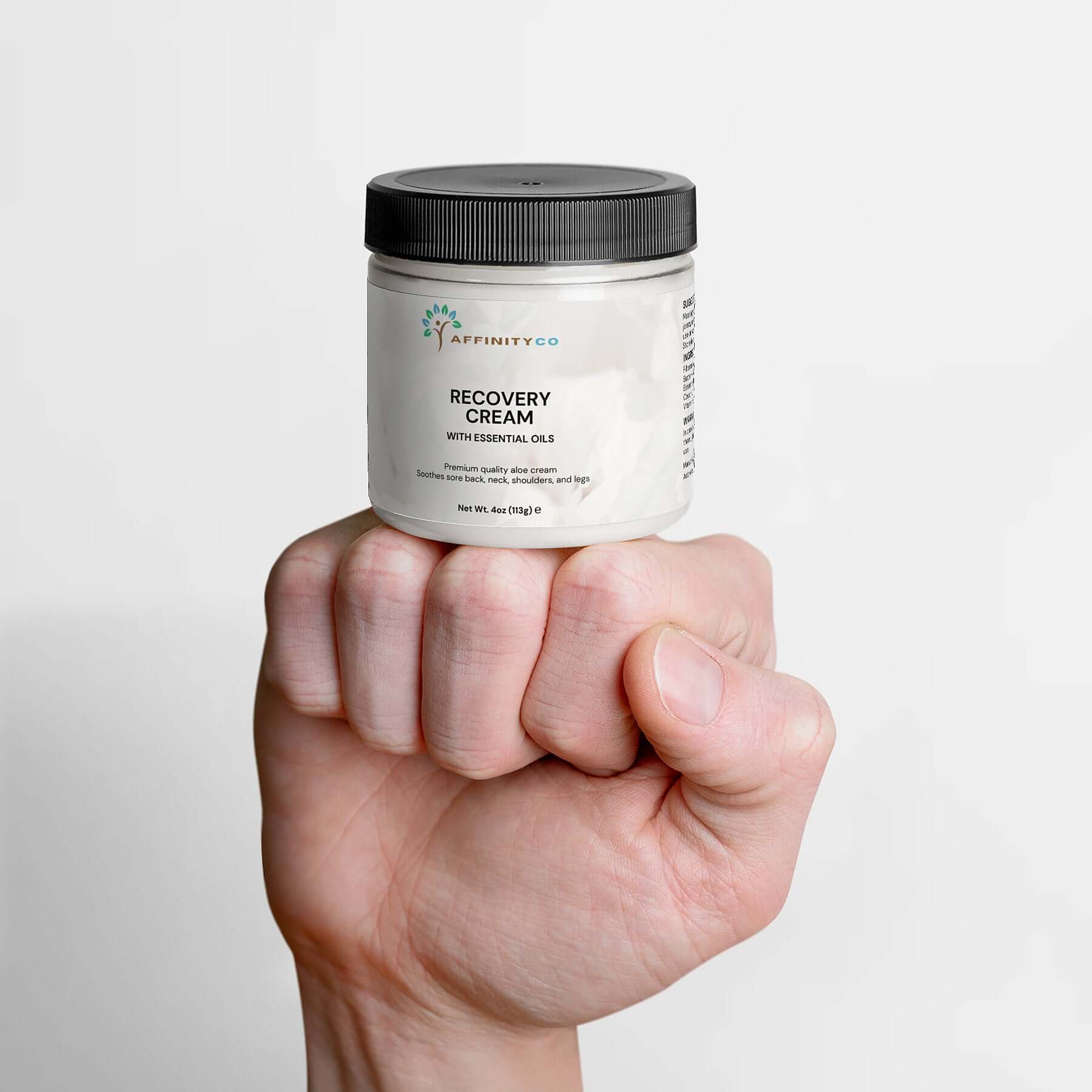 Recovery Cream jar on top of a fist